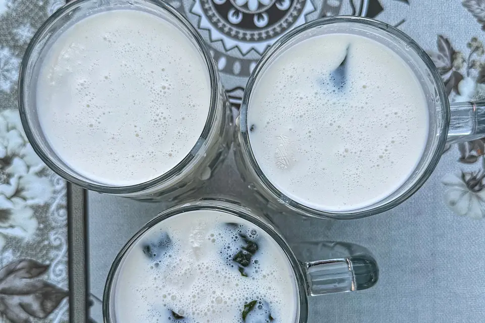 Glasses of frothy ayran seen from above