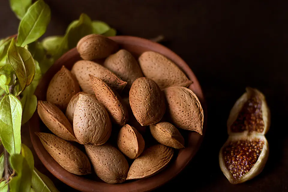 Almonds in their skins in a wooden bowl