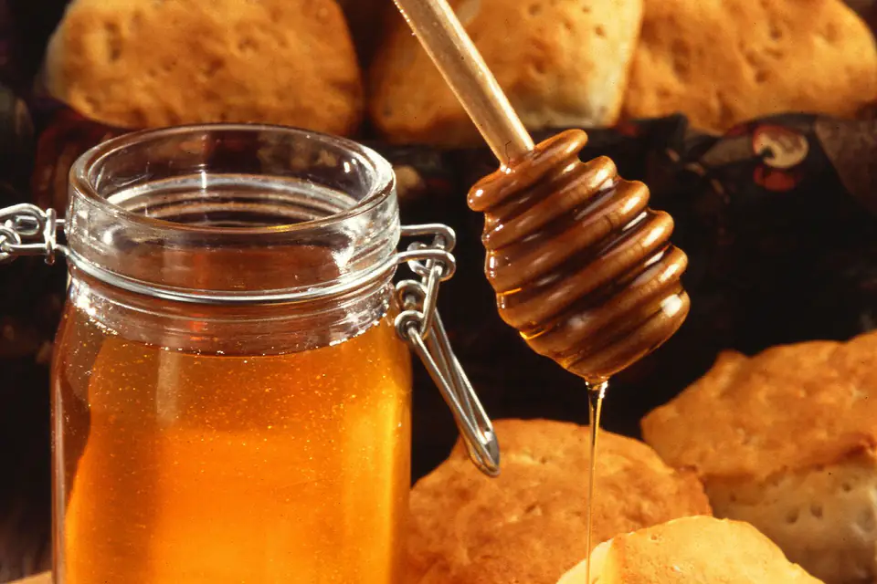 Honey in a jar with a honey dipper