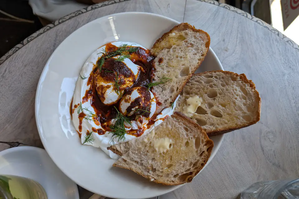 Çılbır: poached eggs on garlic yogurt with red pepper butter and toast