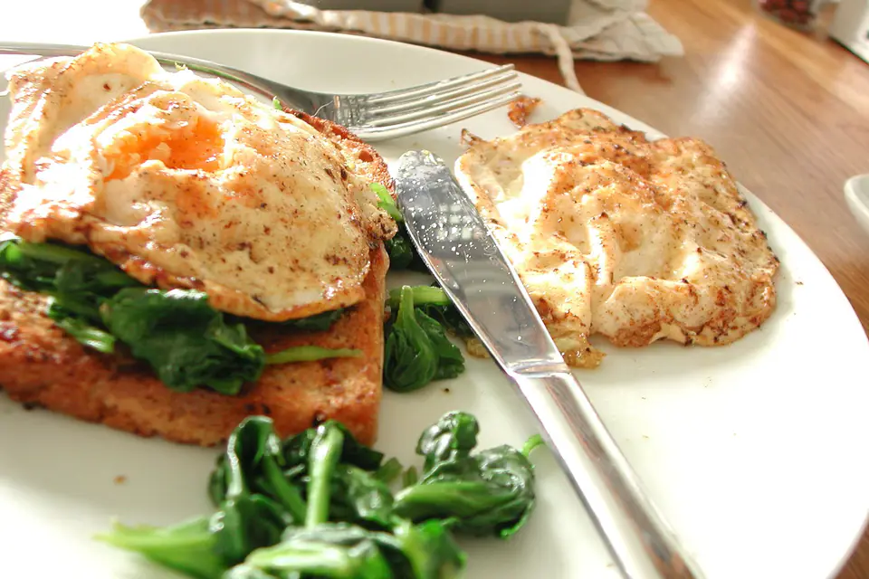 Eggs baked on spinach in a pan