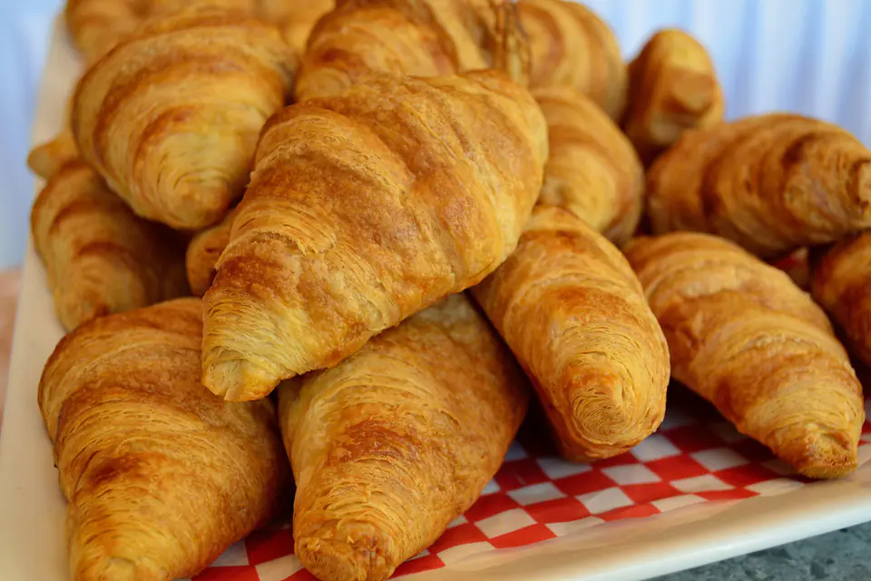 Croissants piled on checkered paper