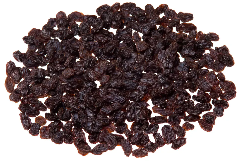 A pile of raisins on a white background