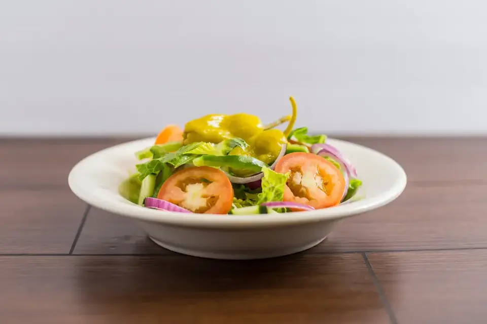 Salad with lettuce, tomato and onion in a bowl