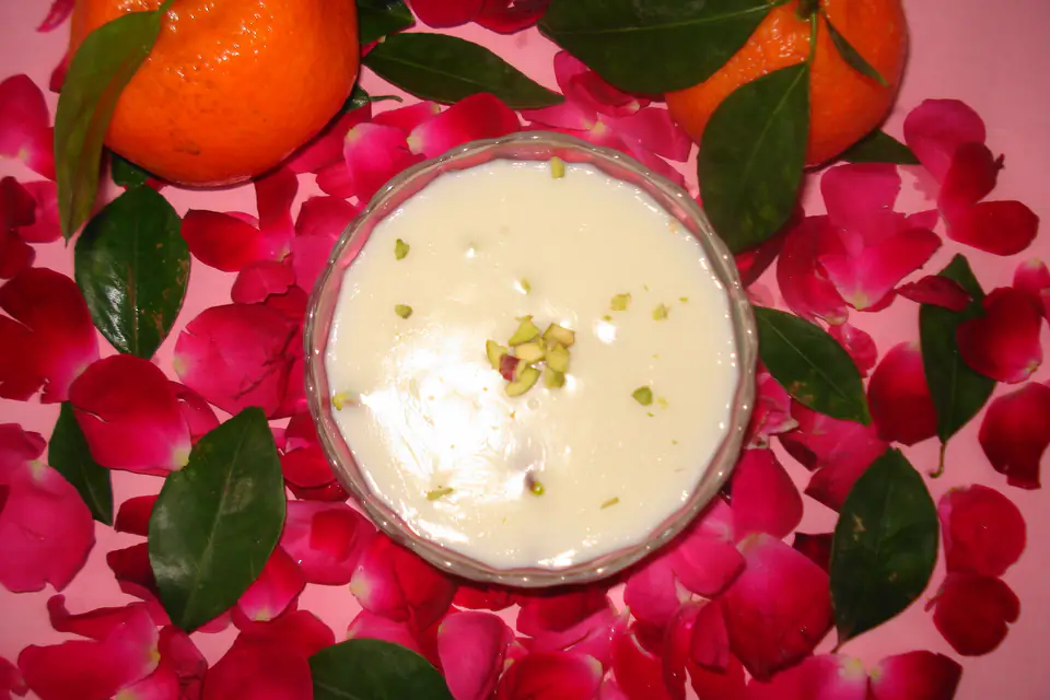 Muhallebi topped with pistachios in a glass bowl