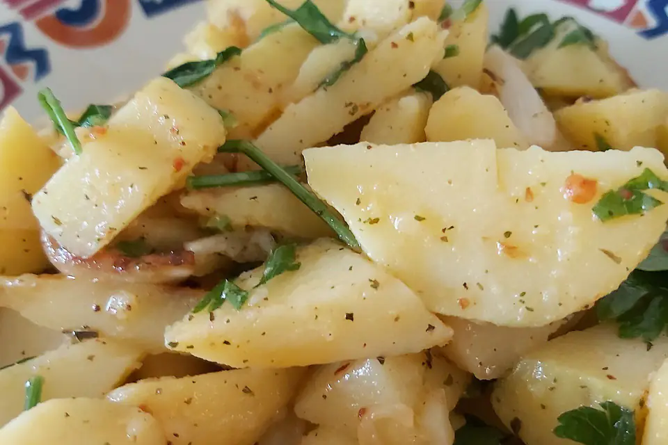 Close-up of potato salad with parsley and onion