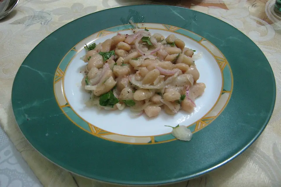 White bean piyaz with onion and parsley on a plate