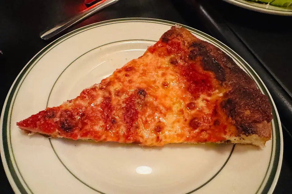 A slice of cheese pizza on a plate