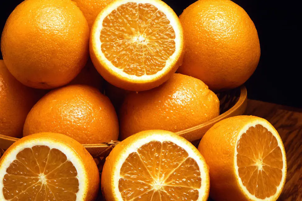 Whole and halved oranges in a basket