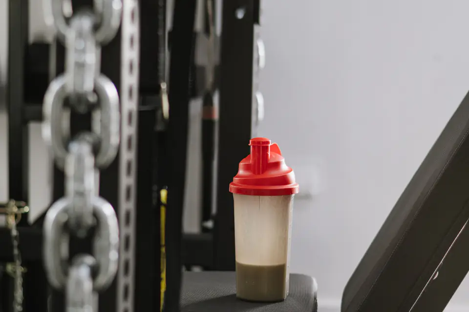 A protein shake in a shaker bottle at the gym