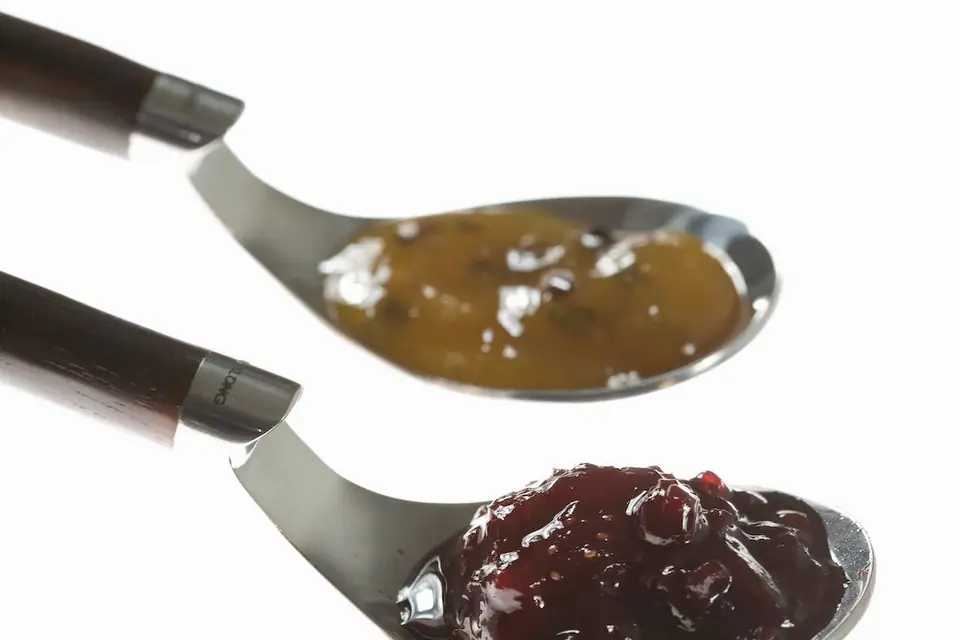 Jam and orange marmalade on spoons