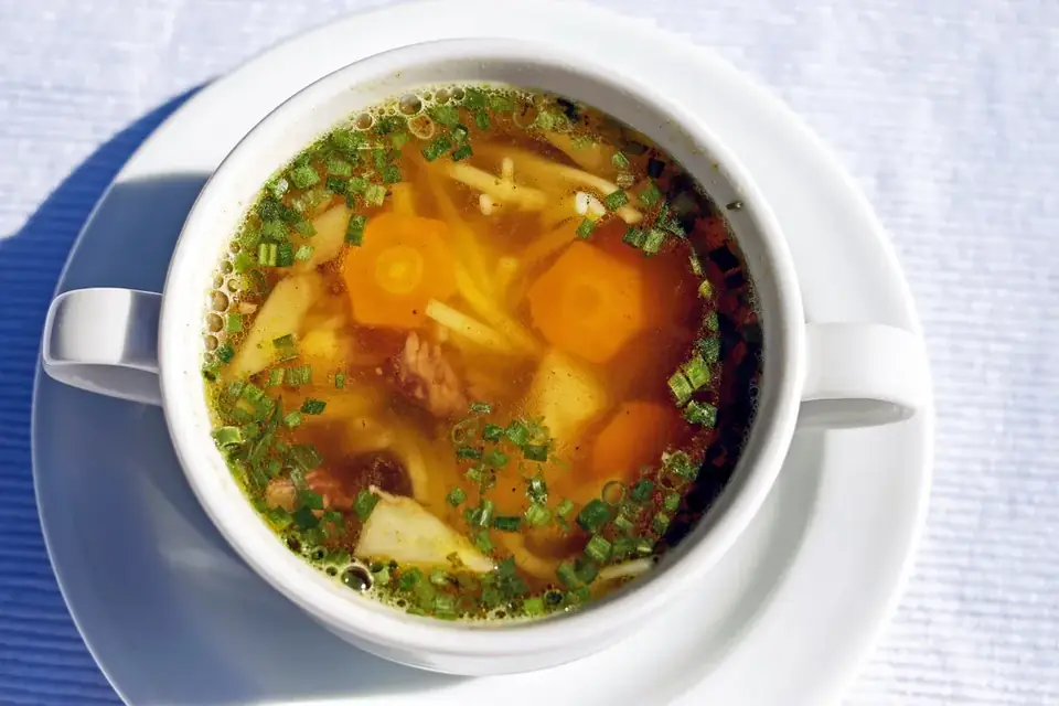 Vegetable soup with carrots in a bowl with handles