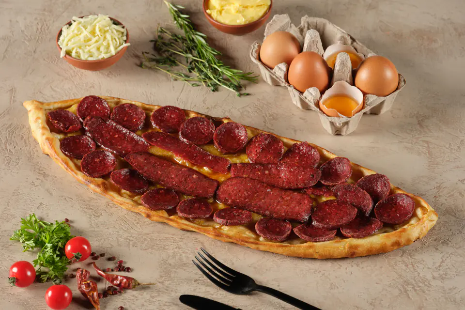 Sucuk pide on a wooden board