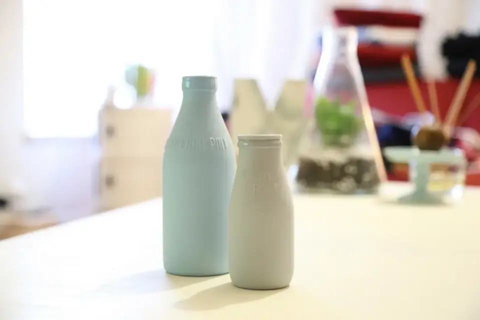 Two bottles of milk on a table