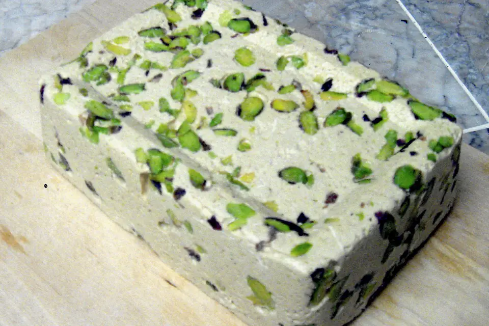 A block of tahini halva with pistachios