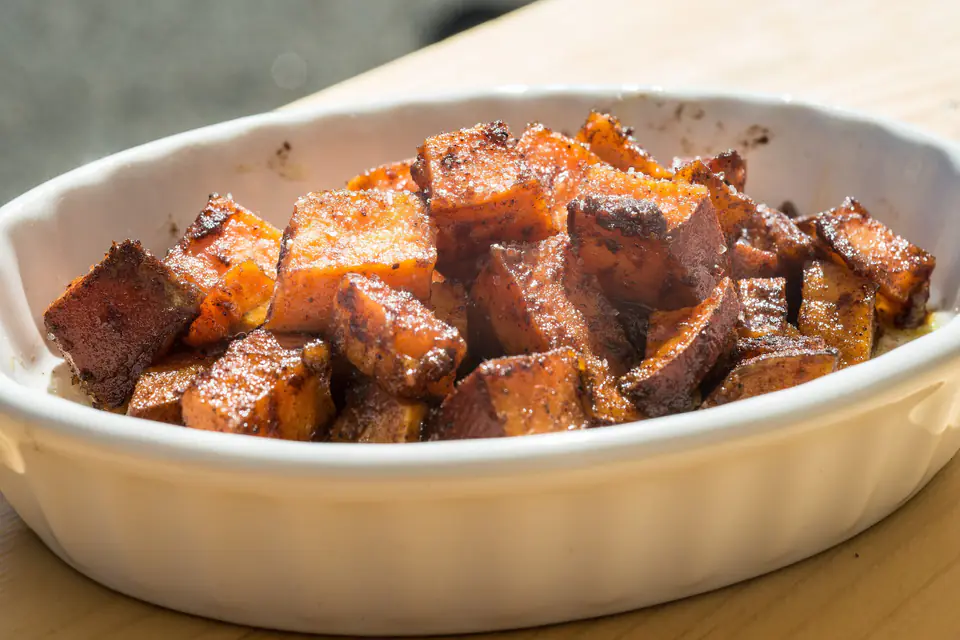 Roasted sweet potato cubes in a baking dish
