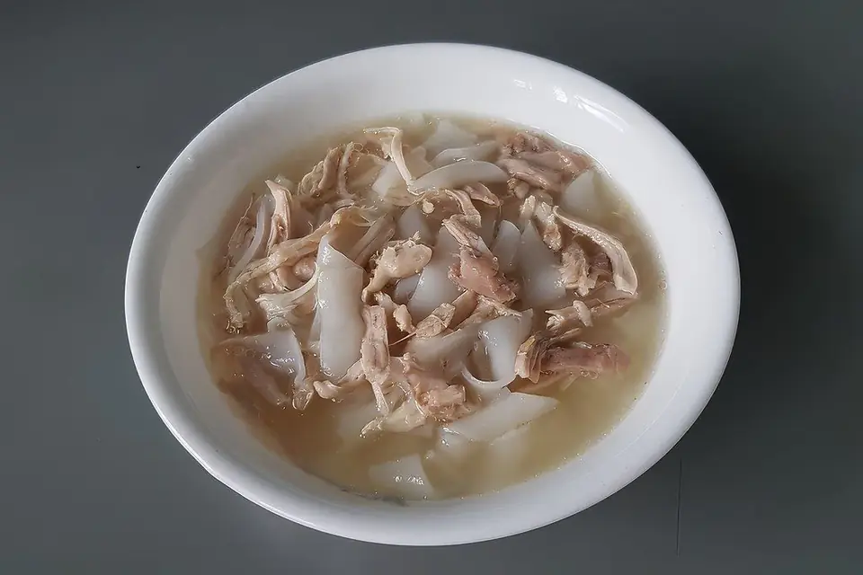 Shredded boiled chicken breast in a bowl