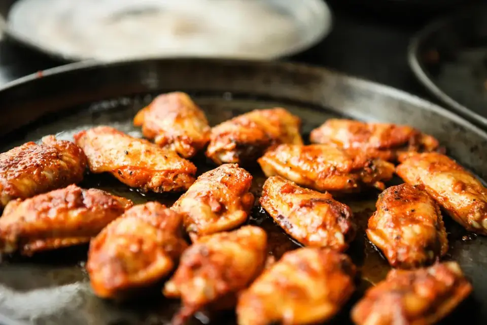 Spicy chicken wings fried in a pan