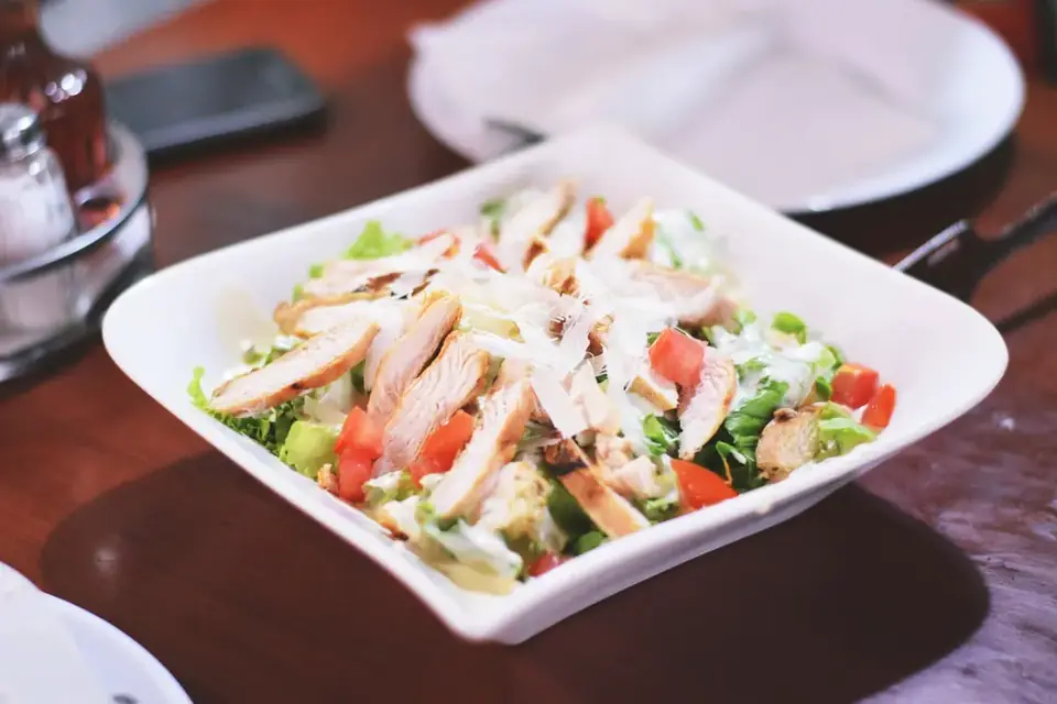 Green salad with grilled chicken in a bowl