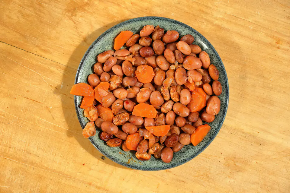Borlotti beans with carrots in olive oil on a plate