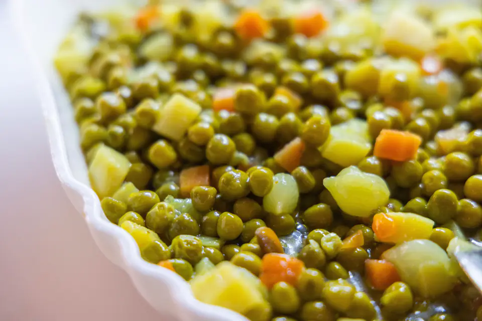 Peas with carrots and potatoes in olive oil