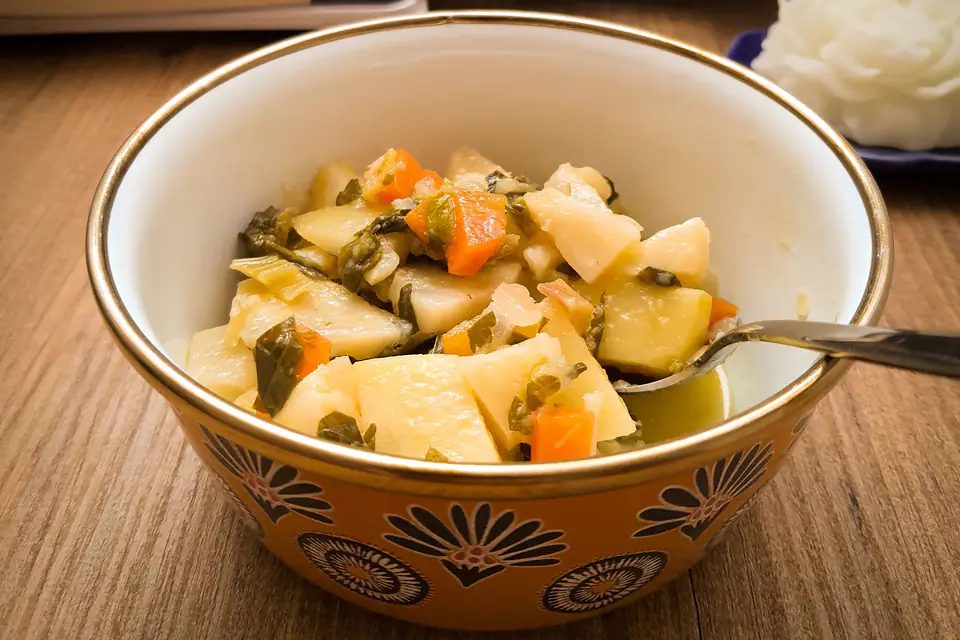 Zucchini with carrots and potatoes in olive oil in a bowl